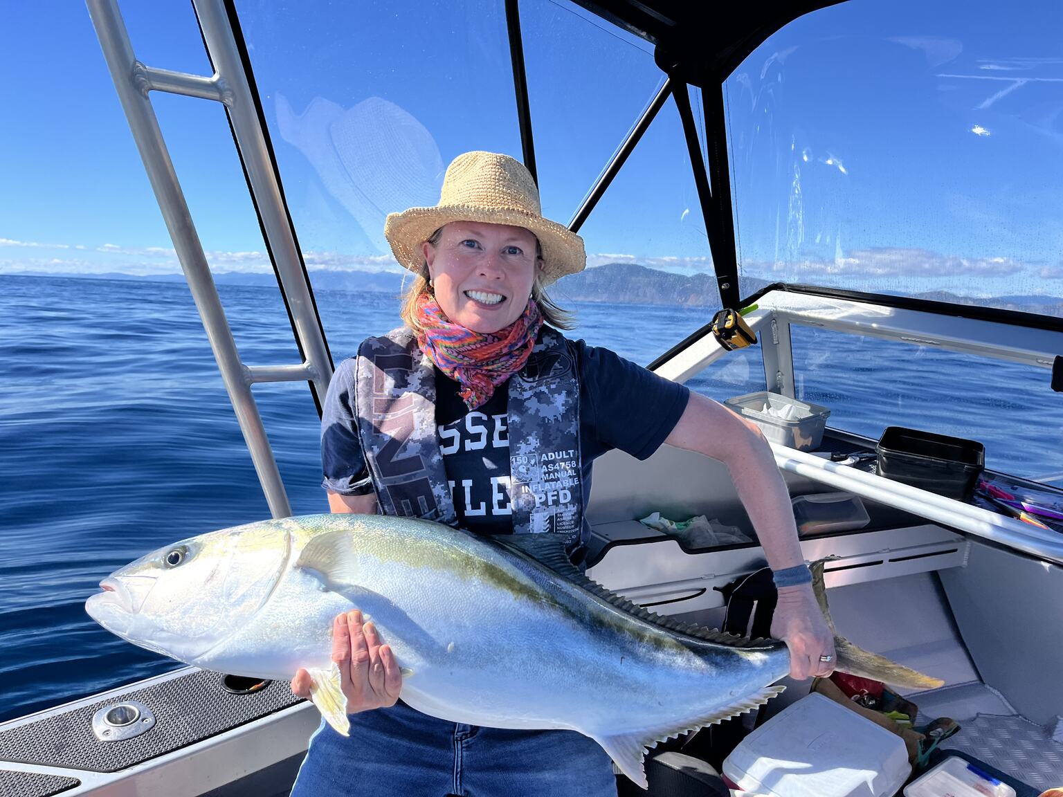 Kate holding a kingfish on a boat