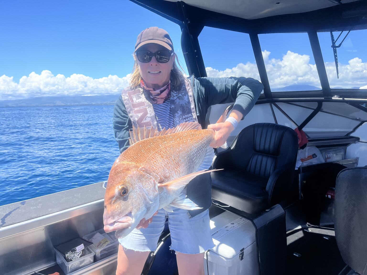Kate holding a snapper on a boat